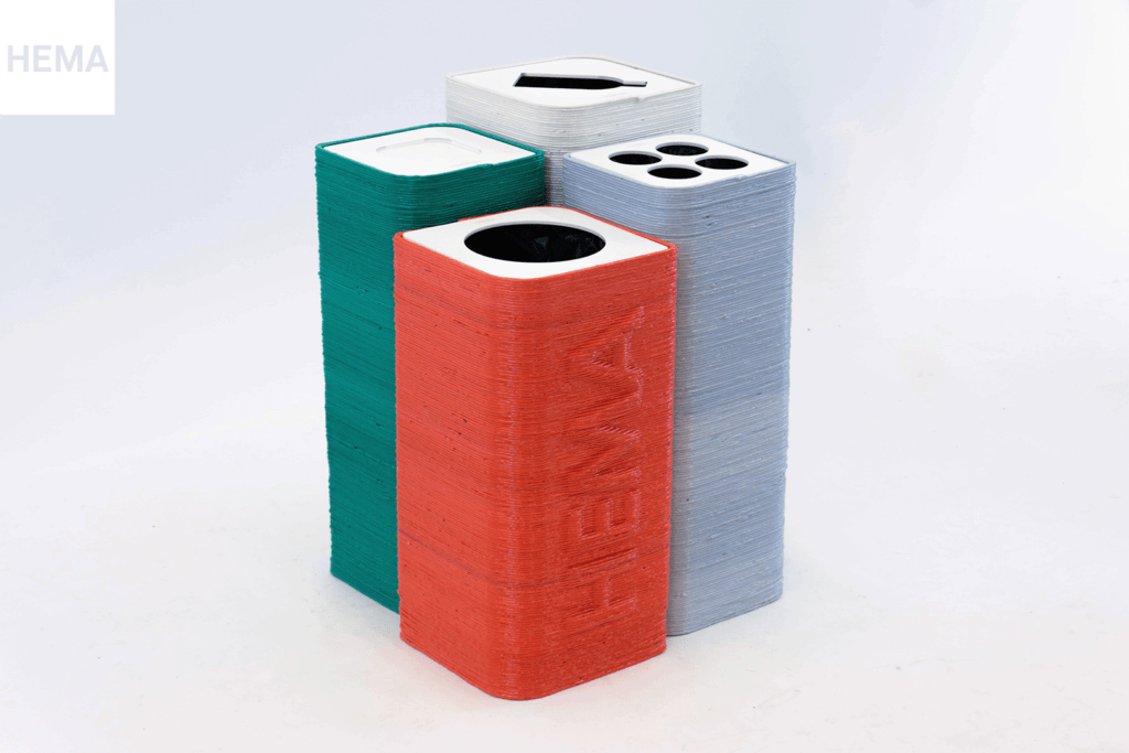 Waste separation bins for HEMA, made from recycled plastic from old make-up displays of HEMA. There are four bins for organic waste, coffee cups, plastic and other waste.
