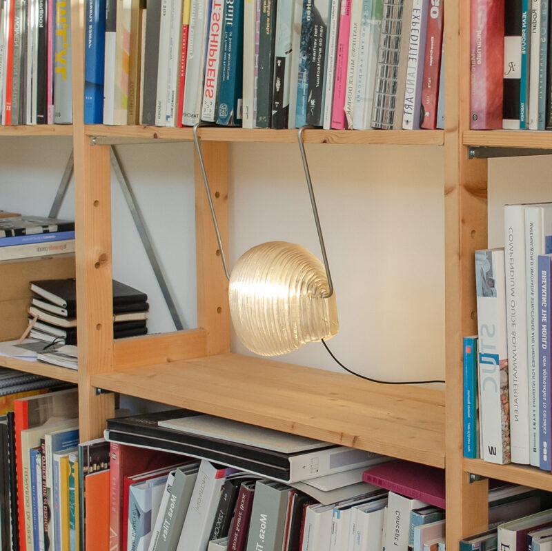 Poko sustainable lamp 3D-printed hanging from bookshelf
