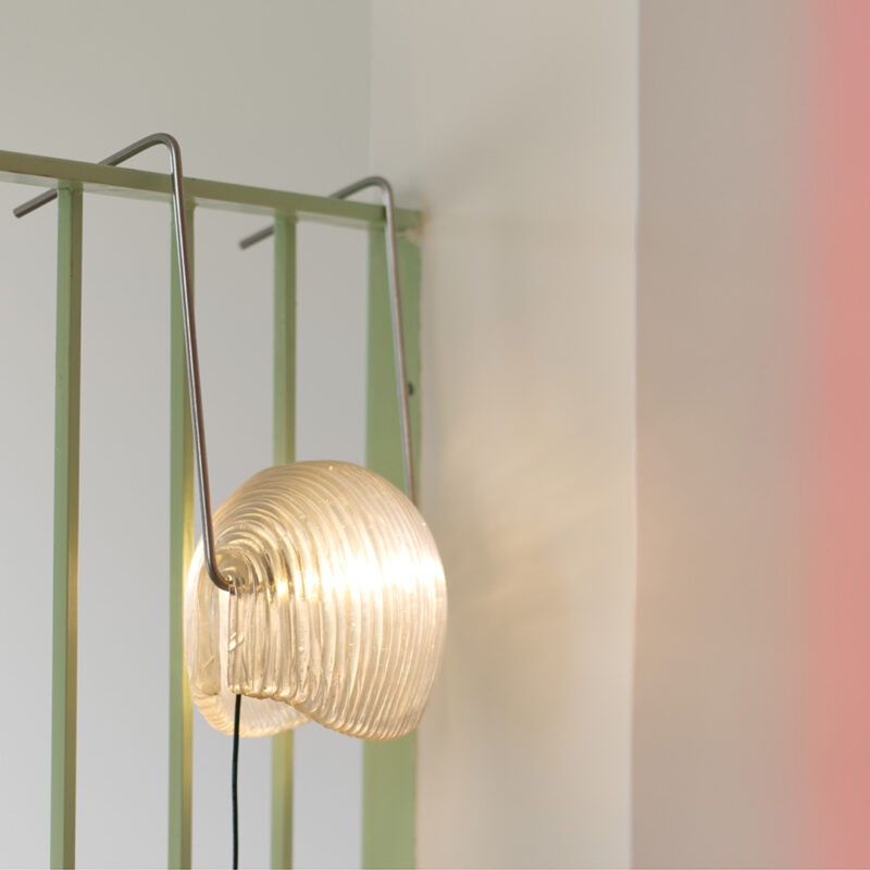 Poko sustainable lamp 3D-printed from recycled plastic, hanging from a banister
