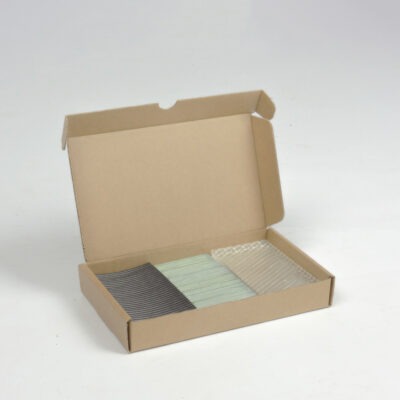 Sample box of 3D-printed recycled plastic in various shapes and materials.